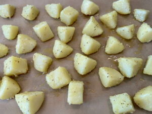 potatoes arranged on the baking sheet